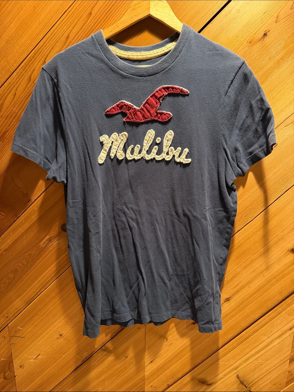 Hollister Blue Tee with Cream 'Malibu' Appliqué and Red Seagull